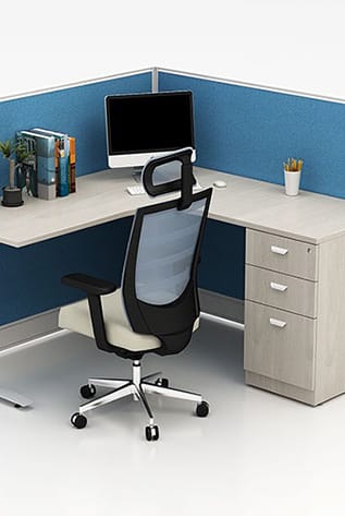 Office workstation featuring low partition screens, desk, chair, and filing cabinet.