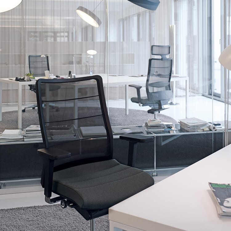 Ergonomic AirPad office chair by Interstuhl with a breathable mesh back in a modern office setting.