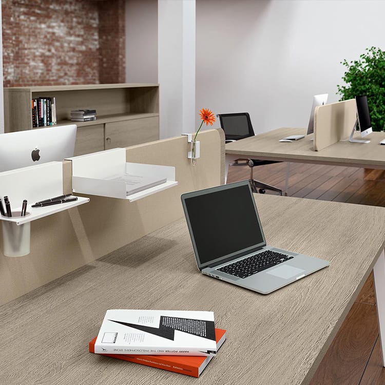 Blade workstation with a laptop, books, and desk accessories in a modern office setting.