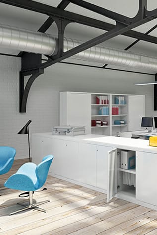 Modern office with white metal Cabinets and blue chairs. Secure storage solutions.
