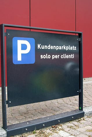Modern black steel Street Furniture sign indicating customer parking.