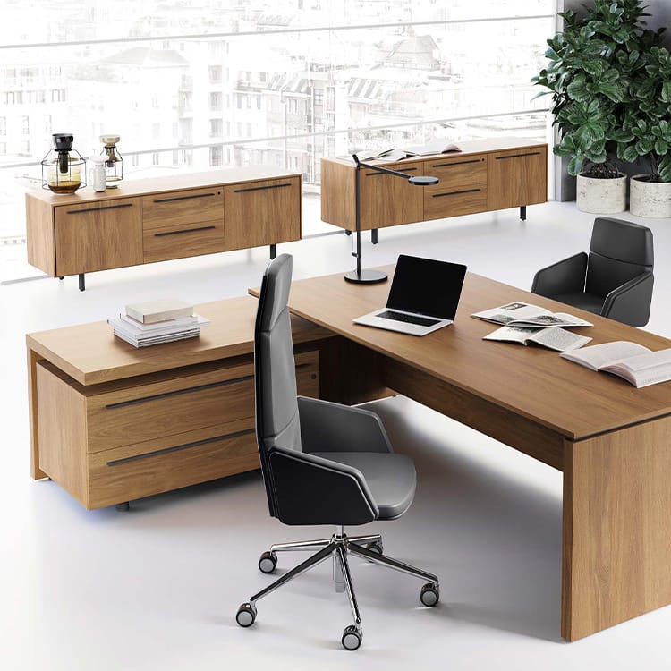 Modern EOS executive desk in wood with black chairs in office setting.