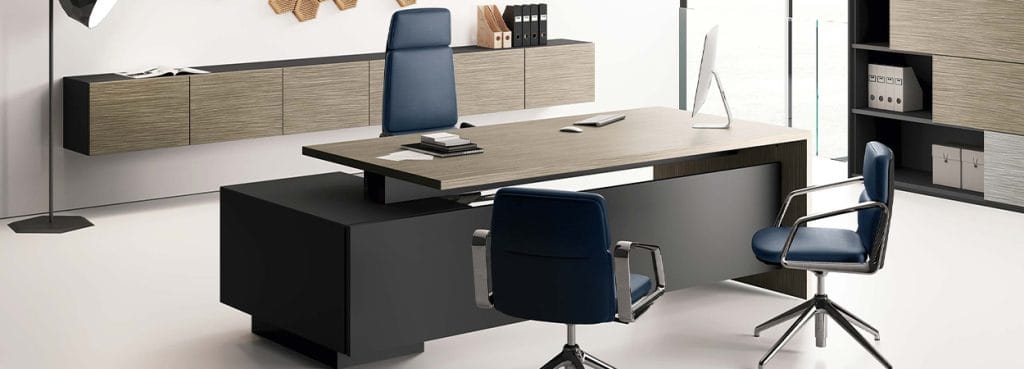 Elite executive desk with wood top, black base, and blue leather chairs for private offices.