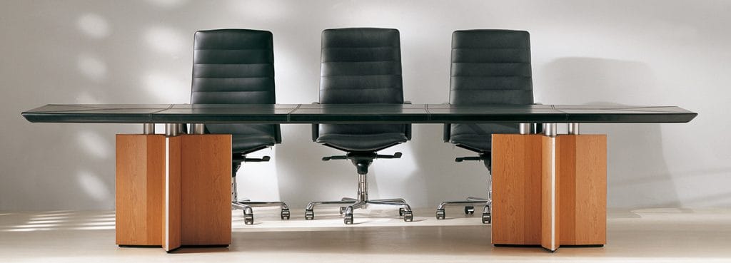 Modern Epico Conference Table with a black tabletop and wood base, paired with three black leather chairs.