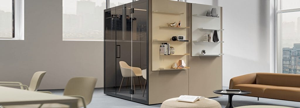 Modern office featuring the F40 acoustic pod with glass walls and shelving, designed for privacy and collaboration.