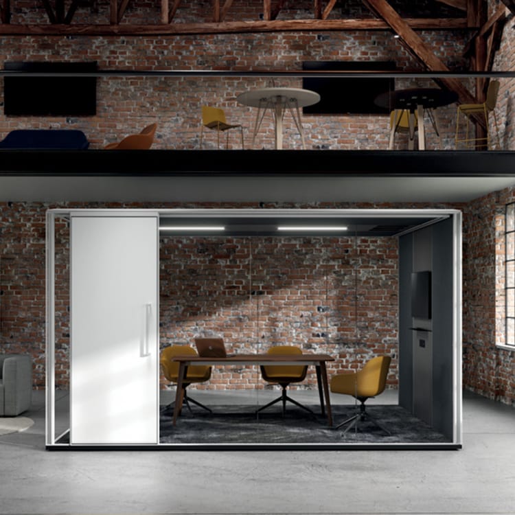 Modern F65 acoustic pod in an open office. Glass walls, white door, and yellow chairs.