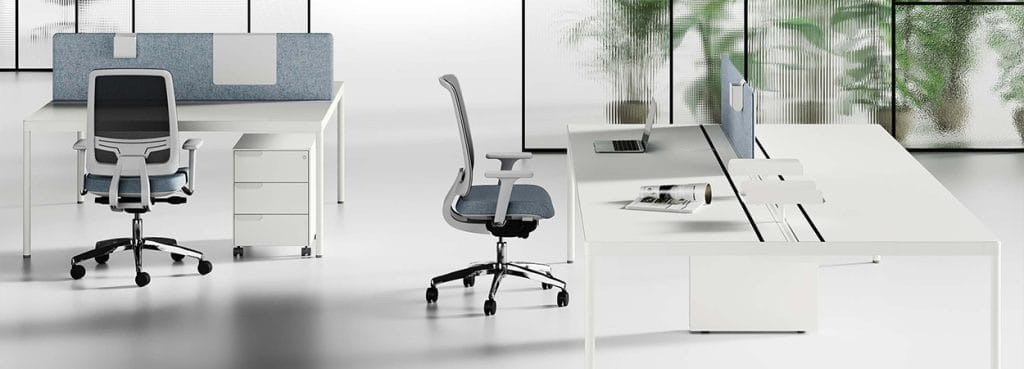 Modern Fil Rouge workstation setup with white desks, office chairs, and sleek design. Ideal for open, operative spaces.