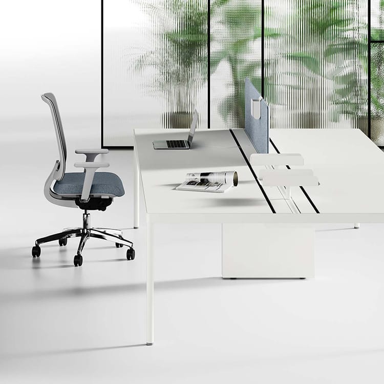 Modern white Fil Rouge desk with a gray chair, laptop, and magazine.
