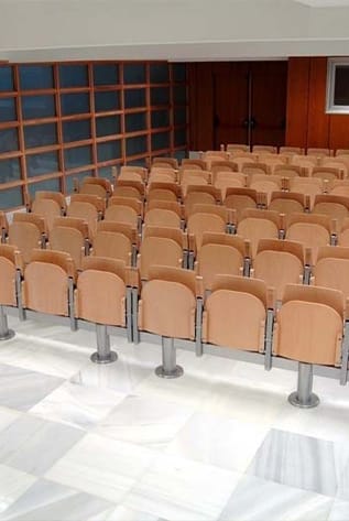 Rows of beige amphitheater seats with metal supports.