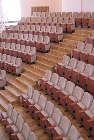 Rows of beige and brown Amphitheater seating on tiered steps.