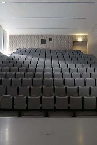 Gray Amphitheater seating, tiered rows, modern design for venues, comfort, and optimal sightlines.