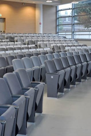 Gray Amphitheater seating in rows, designed for comfort and optimal viewing.