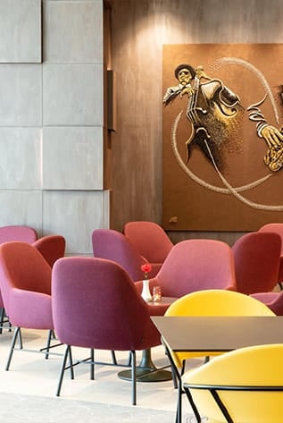 Modern Cafeterias furniture with purple and yellow chairs. Durable, stylish solutions for hospitality spaces.