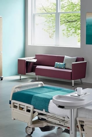 Inviting Healthcare Furniture: Modern plum sofa and adjustable hospital bed create a comforting, healing environment.