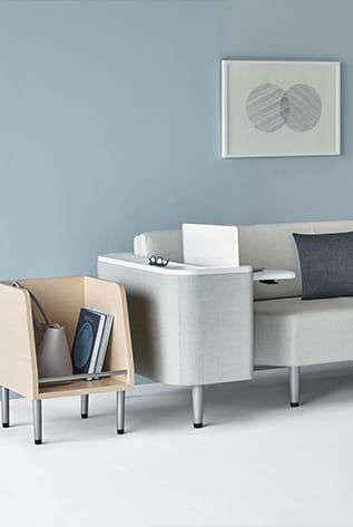 Modern Healthcare Furniture: Light wood storage and gray sofa with integrated table, enhancing patient comfort and organization.