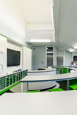 Modern Laboratory Furniture with curved tables and green accents, designed for educational labs.