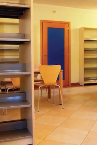 Modern Library Furniture: shelving, table, and chair in a bright, inviting space.