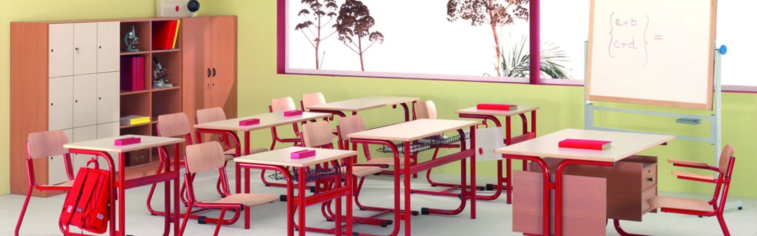Classroom with red School Furniture, desks, chairs, cabinets, and a whiteboard.