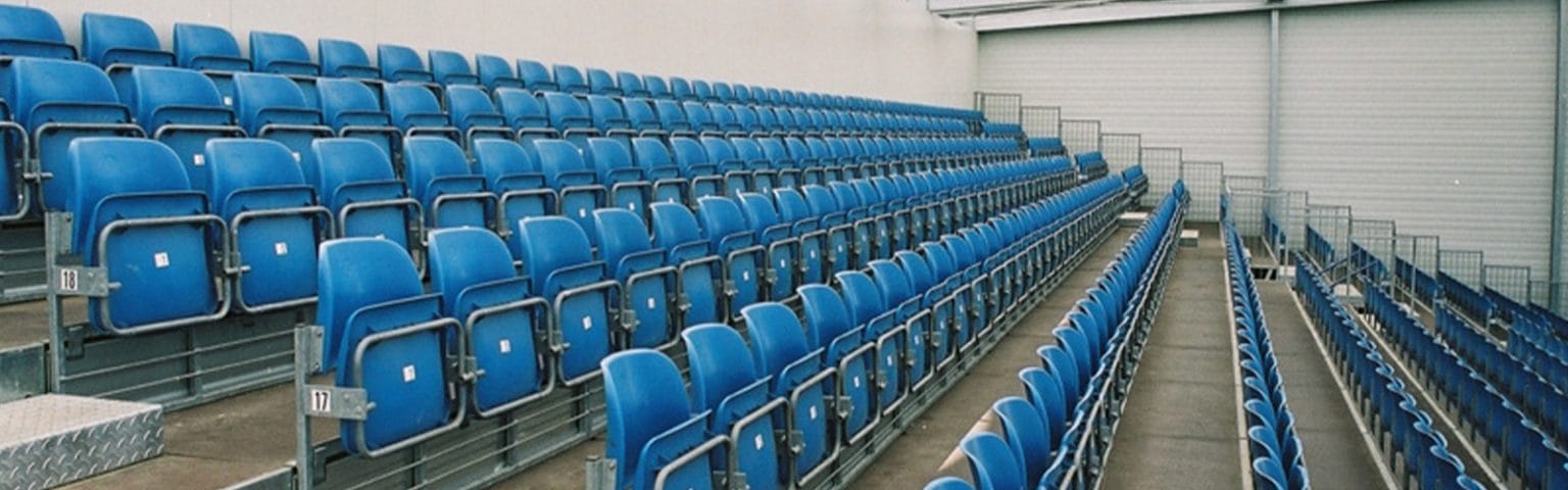 Rows of blue Seating and Staging Solutions for venues, durable and versatile.