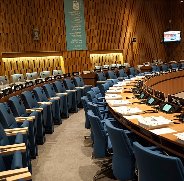 Curved rows of blue seating in wood-paneled Lecture Halls.