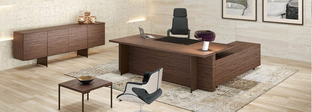 Modern office with wood Oasi executive desk, credenza, and ergonomic chair.