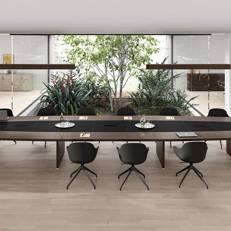 Modern Odeon Conference Table in wood and black with black chairs in a bright meeting room.