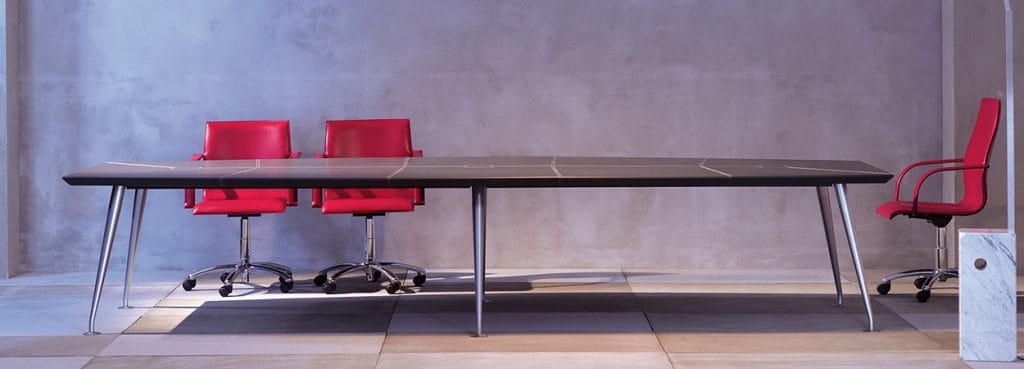 Sleek Orazio Conference Table with a dark top, chrome legs, and red chairs.