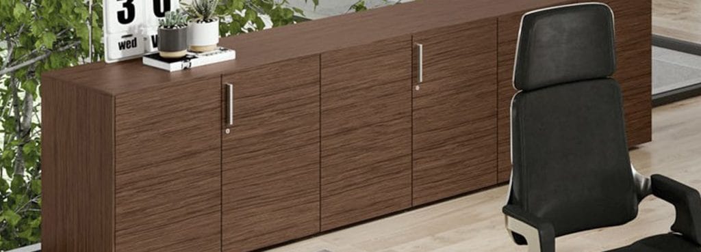 Modern office with wood Ottanta Storage Units and black executive chair.