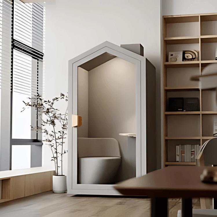 Μινιμαλιστικός γκρι θάλαμος Home Pod με κάθισμα και μικρό τραπέζι στο εσωτερικό. Σύγχρονο, ηχομονωμένο γραφείο για το σπίτι.
