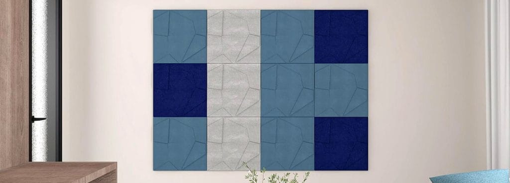 Ηχοαπορροφητικά πάνελ τοίχου 3D από τσόχα Rhythmic Layer, με αλληλοεπικαλυπτόμενα γεωμετρικά επίπεδα σε αποχρώσεις μπλε, γκρι και ναυτικού μπλε.