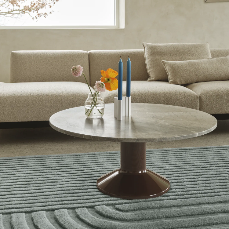 Relevo rug in sage green under a lounge setting